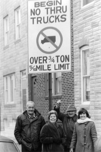 Harry Warren Lowe on far left, SBIC members in center, and Carol Lowe on far right, all sanding under sign erected  as a result of their advocacy.