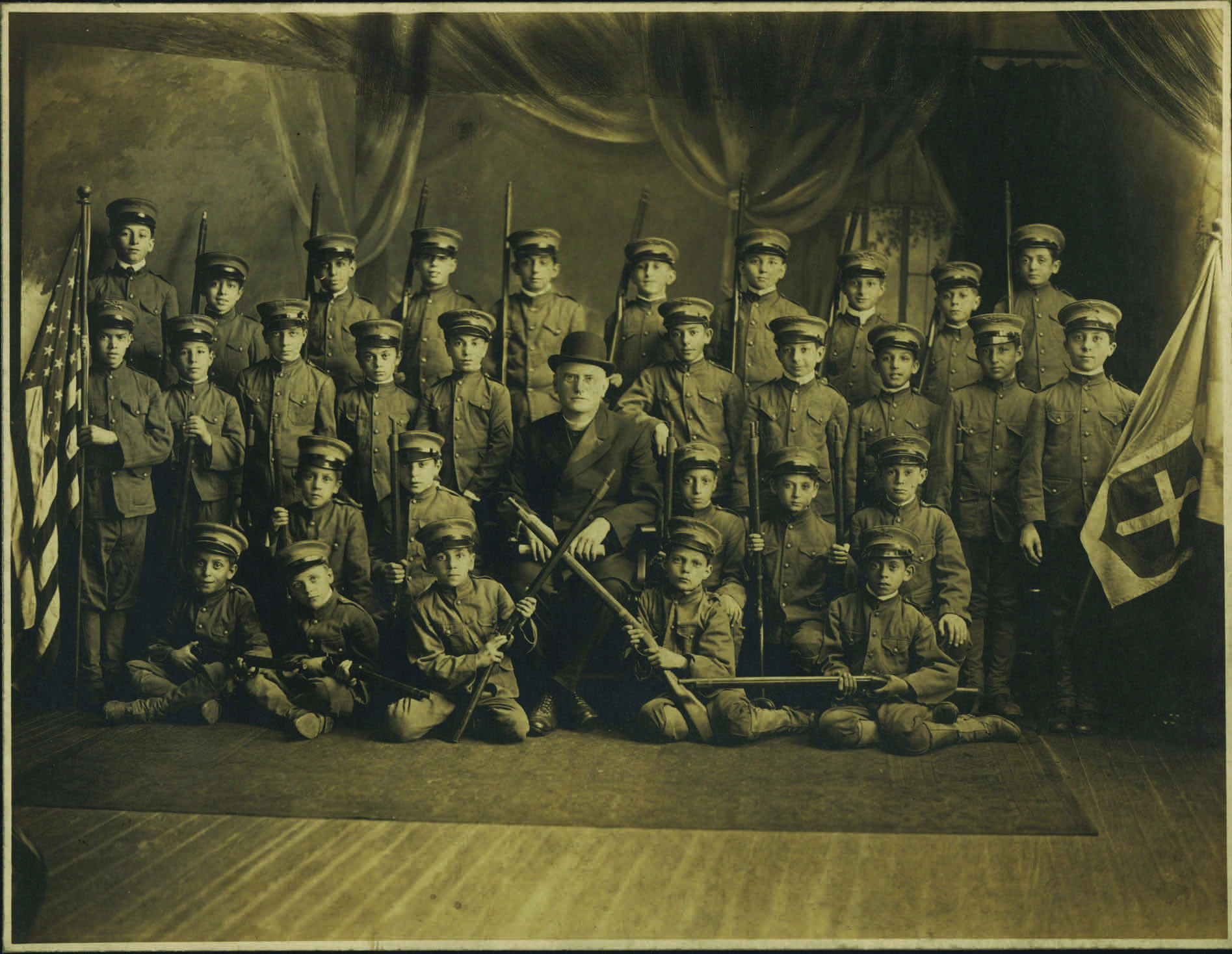A group picture of the cadet club of St. Leo’s Church. Angelo Pente, here a young boy (seated third row from the top, far right), wrote later in life that they used the church basement as their training ground, remarking “it kept the youths out of trouble.”  