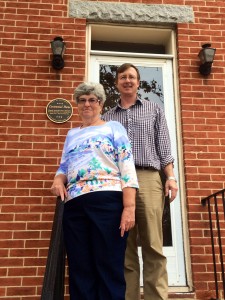 Ms. Jane Buccheri in front of her Centennial Home at 840 W. Pratt St. with Baltimore Heritage Director Johns Hopkins.